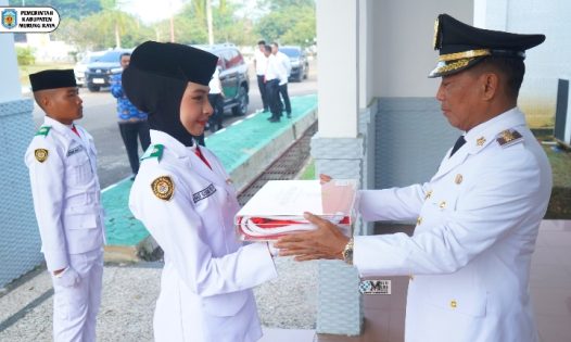 Bupati Heriyus Serahkan Bendera Merah Putih kepada Paskibraka untuk Dikibarkan pada HUT ke-81 RI